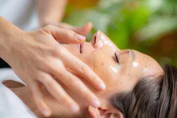 Woman indulges in a luxurious skincare treatment with a face mask at the beauty salon - 781826007