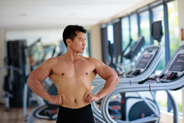 Fototapeta na wymiar Man exercising in gym. Bodybuilder lifting weights