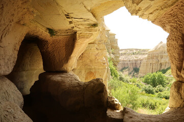 View out of a cave next to the trail leading through the Pigeon Valley, Güvercinlik Vadisi between...