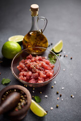 Sliced and chopped tuna fillet in glass bowl at domestic kitchen cooking traditional tartare