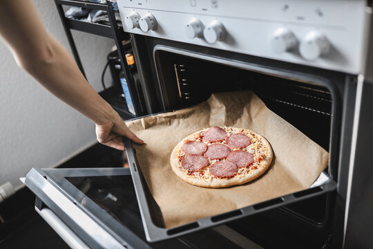 Girl cooking pizza at home