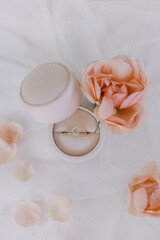 Engagement ring in velvet box with elegant rose decor