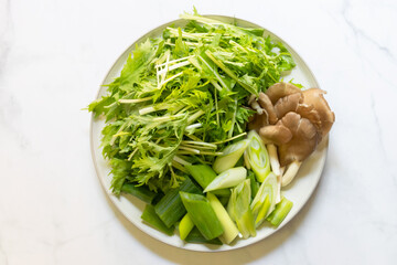Mushroom and vegetables on white plate. 