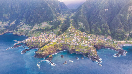 The picturesque village of Seixal in Madeira, nestled between green mountains and the azure ocean,...