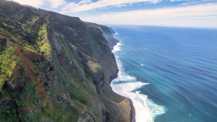 Breathtaking Madeira panorama - powerful cliffs, surging sea, foamy cascades, and lazy clouds. The...