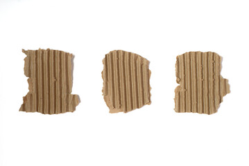Set of three pieces of corrugated cardboard with torn edges isolated on white background.