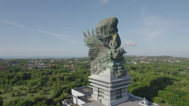 Aerial view on Garuda Wisnu Kencana Monument statue in Bali with Zoom effect. Religious statue of God riding an eagle from Balinese mythology