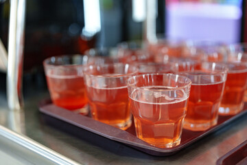 Colorful Array of Fruit Juice Cups on a Serving Cart in a Cafeteria