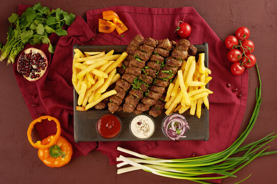 grilled meat, vegetables and French fries. Food Still life