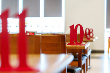Vibrant Red Table Number 10 Displayed in a Sunny Restaurant Setting