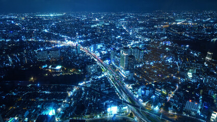 view of the Saigon Ho Chi Minh city at night, blue color traffic road lights and urban connection