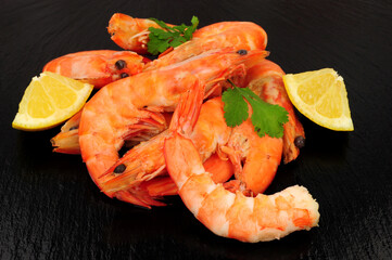 Group of freshly cooked shell on crevettes with lemon and parsley herb garnish