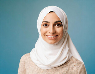 Studio portrait of young woman arab wearing white hijab smiling happy