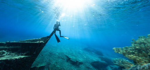 Freediver Sitting on Shipwreck in Shallow Sea With Sea Grass. - 781887218