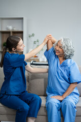 senior woman doing exercise at clinic with physiotherapist. help of a personal trainer during a rehabilitation session.