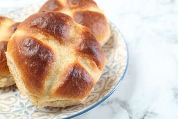Hot cross buns on white marble table, closeup. Space for text