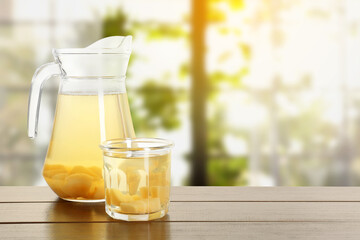Delicious quince drink on wooden table indoors. Space for text