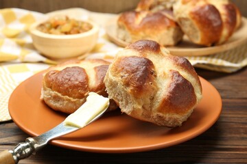 Tasty hot cross buns on wooden table, closeup