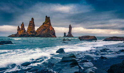 Gloomy morning view of Reynisdrangar cliffs. Picturesque summer seascape of Atlantic ocean. Spectacular outdoor scene of black sand beach in Iceland, Vik location. Travel the world.. - 781890090