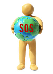 Yellow plasticine human figure holding planet with word SOS isolated on white