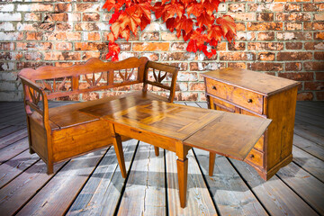 Old italian furniture just restored against a brick wall - concept image