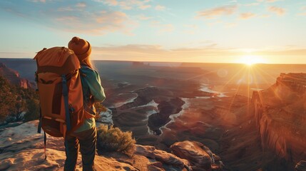 Backpacker Enjoying Breathtaking Sunrise Over Canyon - obrazy, fototapety, plakaty