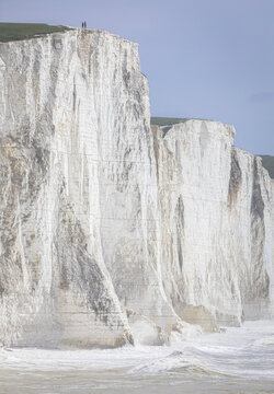 Standing on the cliff edge Cuckmere Brow of the Seven Sisters cliffs east Sussex south east England UK