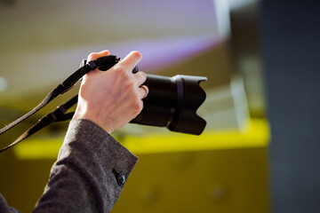 Person capturing moment with camera at automotive event