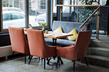 Restaurant with furniture, stairs, wood tables and chairs in a cozy building