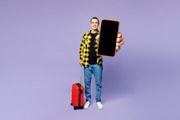 Traveler man wear yellow casual clothes hold bag use blank screen mobile cell phone isolated on...