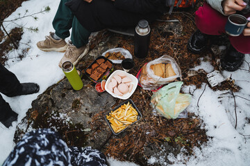 camping in the forest, breakfast in nature, hiking in the forest, food lying on a rock, sausage, bread, thermos with tea.