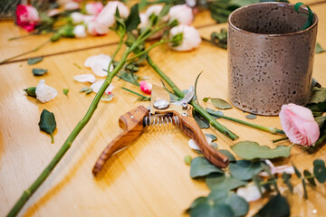 Scissors on table by flowers for arranging bouquets at event