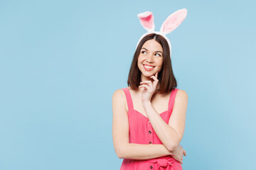 Young minded woman wear pink casual clothes rabbit bunny ears put hand prop up on chin look aside...