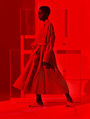 Scarlet Elegance A Runway Model in Red, Showcasing the Latest Fashion Fabrics and Textures