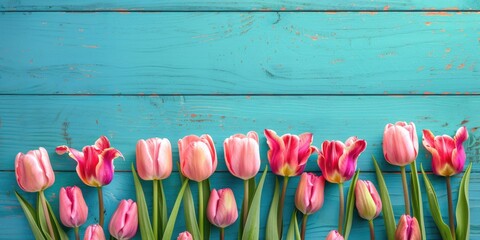Spring Tulip Border with Copy Space. Beautiful Frame Composition of Pink Tulips on Turquoise Blue Vintage Wooden Background for Product Templates