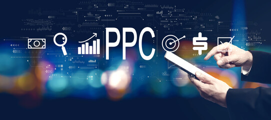 PPC - Pay per click concept with businessman using a tablet computer at night - 781911672