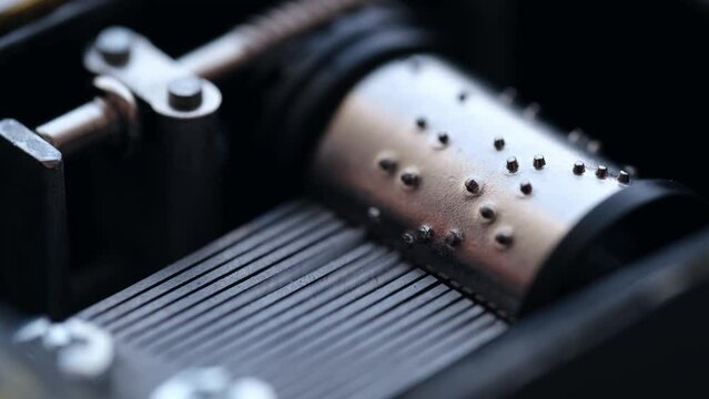 Spinning cylinder of the music box in closeup. Musical mechanism.