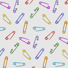Multi-colored pins on a gray background.Vector seamless pattern with multi-colored safety pins on a gray background.