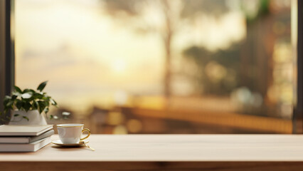 A wooden tabletop with a space for display products with a blurred background of a sunset view.