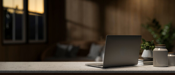 A laptop computer on a desk in a contemporary living room in the evening. place of work concept