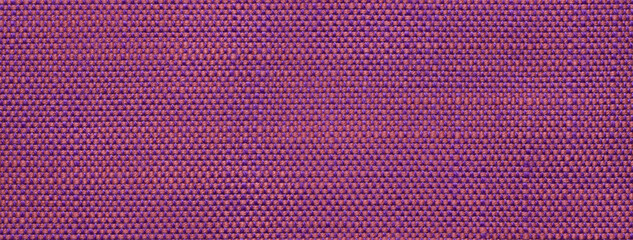 Texture of purple background from woven textile material with wicker pattern, macro. Vintage magenta fabric cloth
