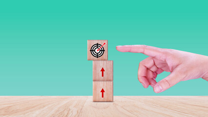 Hands place virtual target board and arrows on wooden block, Business success goals and objective...