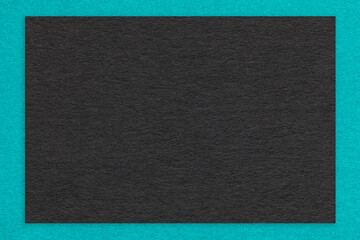 Texture of craft black color paper background with turquoise border, macro. Vintage cerulean...