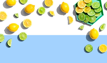 Fresh lemons and limes overhead view - flat lay