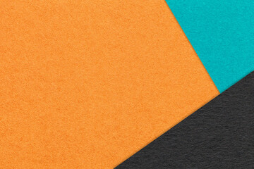 Texture of craft orange color paper background with turquoise and black border. Vintage abstract ginger cardboard.