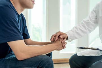 Asia man smiling after consult Psychiatrist ,mental health problems, psychiatrist is recording...