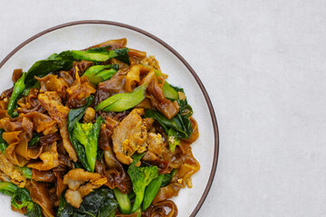 Stir-fried rice noodles with soy sauce and pork