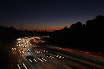 Countless cars stream along Highway 24 in Oakland at sunset, heading inland from San Francisco and the rest of the Bay Area.