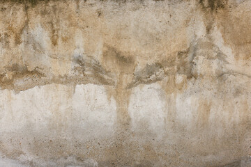 Old water damaged grey plaster wall surface with yellow smudges. Full-frame flat background and...
