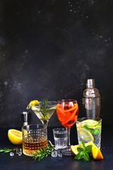 Set of alcoholic drinks (vodka, whiskey, aperol spritz, martini, lemon mojito ) on the bar counter. - 781939026